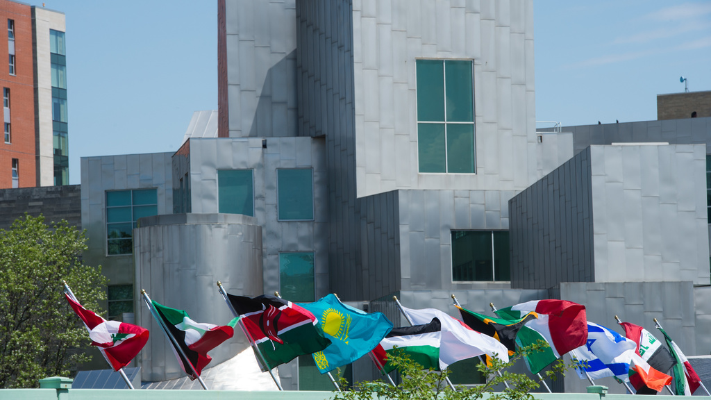 Image of a footbridge off the Iowa Advanced Tech Lab displayed with flags for International Student Week