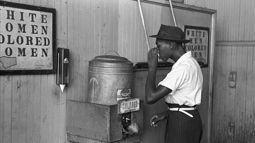 "Colored" drinking fountain from mid-20th century with African-American drinking 